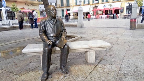 The statue of Pablo Ruiz Picasso sat on a bench in Malaga