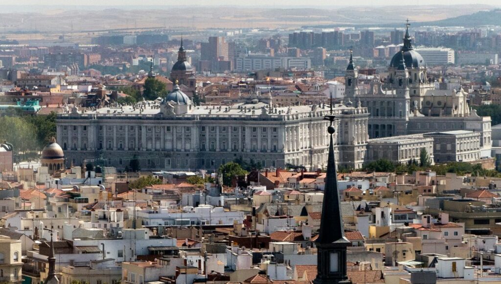 The Madrid skyline focusing on the Royal Palace and the Cathedral.
