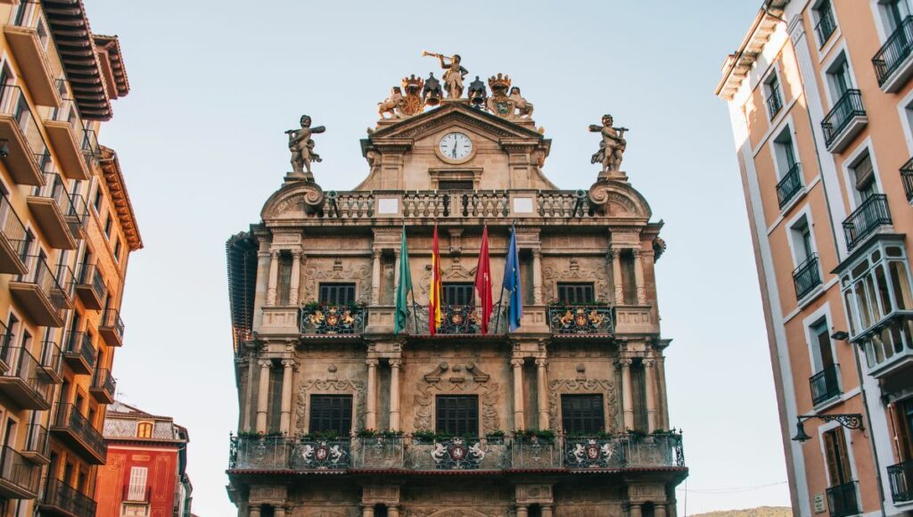 A photo showing the flags and clock in the Town Hall (Ayuntamiento) in Pamplona, Navarra