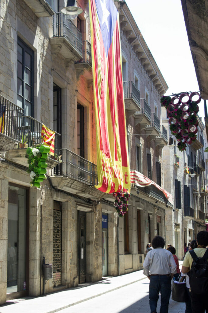 A Catalan flag hangs from a building in old town Girona