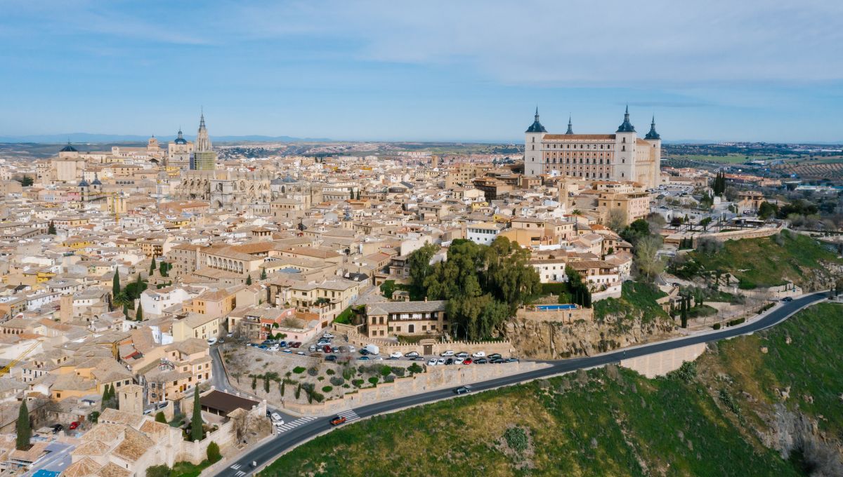 The Toledo city skyline dominated by the Alcazar with a blue sky.