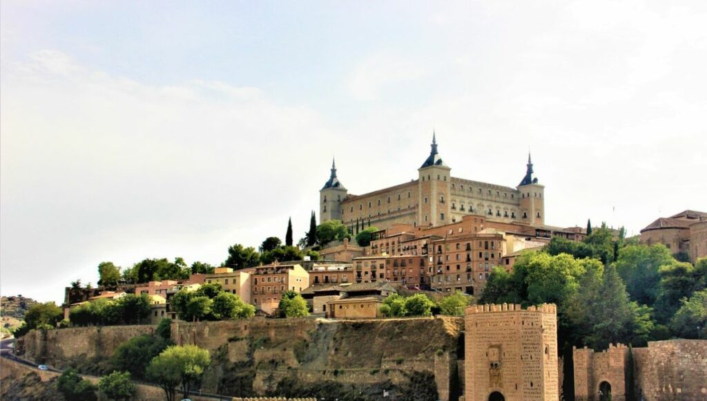 The Alcazar of Toledo against a grey sky from the other side of the river