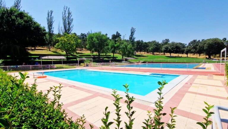 The clean blue water of the two pools at La Piscina Municipal de Tamames on a sunny day