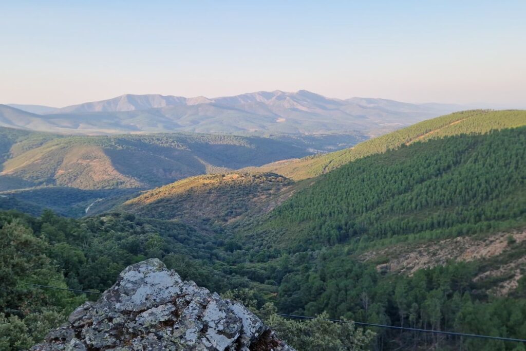 Scenic view of the Sierra Francia, showcasing rolling green hills and distant mountains under a clear blue sky.